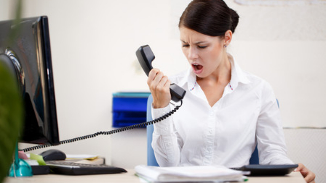 Angry woman on the phone on hold with a business