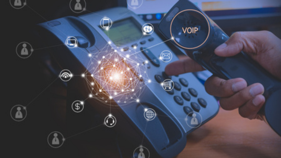 Hnad of man using a VoIP phone system and VoIP network